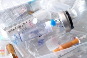 medical syringes and ampoules of plastic and glass that were in use, waste, close-up