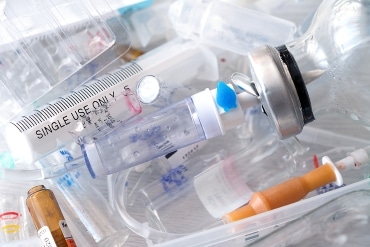 medical syringes and ampoules of plastic and glass that were in use, waste, close-up