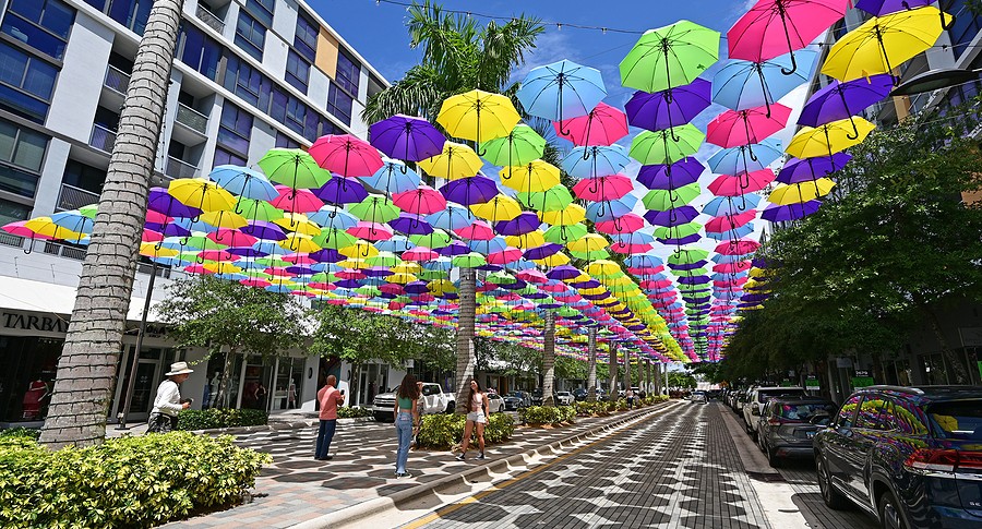 Visitors enjoy canopy of colorful umbrellas suspended over Doral CityPlace boulevard on sunny sunday morning.